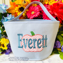Load image into Gallery viewer, Boys Halloween Basket Blue Gingham with 'Everett' embroidered on it, surrounded by colorful flowers.